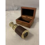 A MINI BRASS AND LEATHER TELESCOPE IN WOODEN BOX