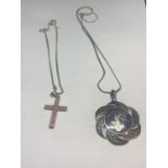 TWO SILVER NECKLACES WITH PENDANTS TO INCLUDE A SIAM AND A CORAL COLOURED CROSS