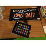 A LIGHT UP MAN CAVE WALL SIGN AND A LARGE DIGITAL CALCULATOR