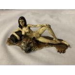 A COLD PAINTED BRONZE FIGURINE OF A NUDE LADY LYING ON A TIGER RUG