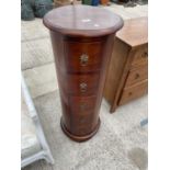 A CYLINDRICAL MAHOGANY CHEST OF FIVE DRAWERS