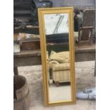 A GILT FRAMED BEVELED EDGE MIRROR