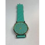 A TURQUOISE GENEIVE WRIST WATCH SEEN WORKING NO WARRANTY