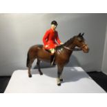 A BESWICK HUNTSMAN ON A BAY HORSE