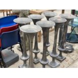 A COLLECTION OF SEVEN TALL METAL VASES