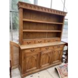 A SUBSTANTIAL PINE DRESSER WITH THREE CUPBOARDS AND DRAWERS TO THE BASE, THE UPPER PORTION WITH