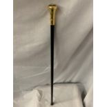 A BLACK WALKING STICK WITH A YELLOW METAL MASONIC TOP