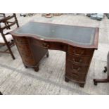 A MAHOGANY KNEEHOLE DESK WITH LEATHER TOP AND NINE DRAWERS