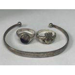 A SILVER BANGLE AND TWO SILVER RINGS