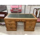 A MODERN PINE TWIN PEDESTAL OFFICE DESK WITH INSET LEATHER TOP, ENCLOSING SIX DRAWERS (ONE BEING A