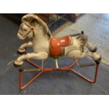 A VINTAGE METAL ROCKING HORSE ON SPRINGS - HANDLES MISSING