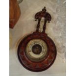 A VINTAGE ORNATE WOODEN CASED BAROMETER WITH THERMOMETER