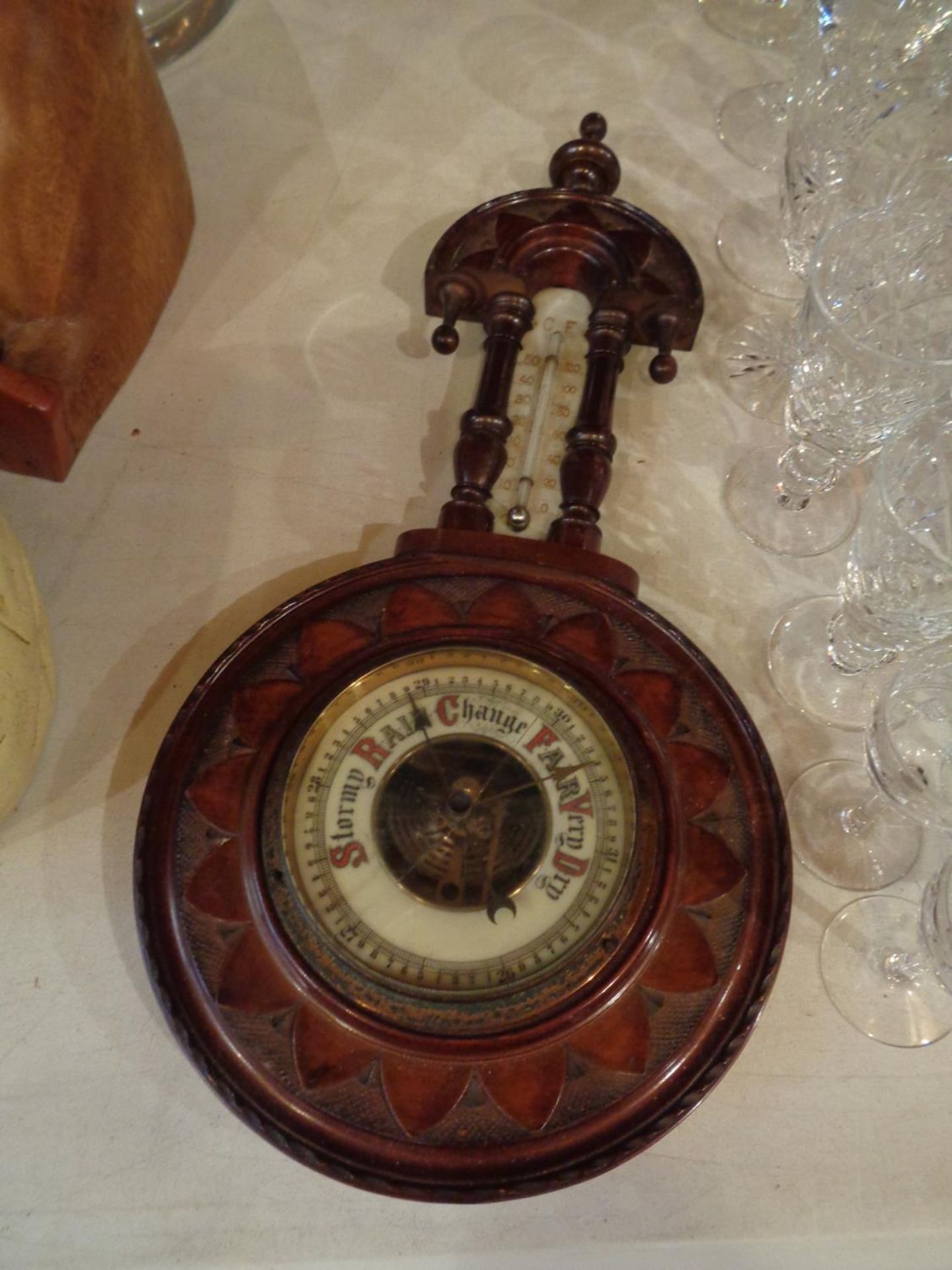 A VINTAGE ORNATE WOODEN CASED BAROMETER WITH THERMOMETER