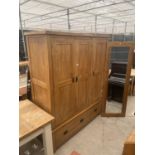 A MODERN OAK THREE DOOR WARDROBE WITH TWO DRAWERS TO THE BASE, 62" WIDE AND A MIRROR 71X23.5"