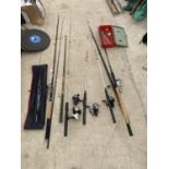 AN ASSORTMENT OF FISHING RODS WITH REELS AND A TACKLE BOX