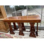 A VICTORIAN MAHOGANY ALTAR TABLE STANDING ON EIGHT GOTHIC SUPPORTS WITH TURNED STRETCHERS, 74" WIDE,