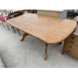 A PINE DINING TABLE ON TWIN PEDESTAL SUPPORTS