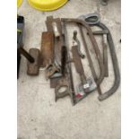 AN ASSORTMENT OF TOOLS TO INCLUDE BOW SAWS, A TROWEL AND SLEDGE HAMMER HEAD ETC