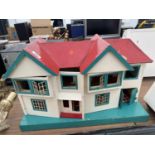 A VINTAGE WOODEN DOLLS HOUSE WITH A SMALL AMOUNT OF FURNITURE