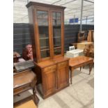 A VICTORIAN MAHOGANY TWO DOOR GLAZED BOOKCASE ON BASE ENCLOSING TWO CUPBOARDS, 37" WIDE