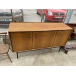 A MID 20TH CENTURY TEAK SIDEBOARD ENCLOSING THREE DRAWERS AND THREE CUPBOARDS, ON OPEN BLACK PAINTED