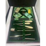 AN ANTIQUE CASED SEWING KIT