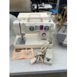 A NEW HOME SEWING MACHINE WITH CARRY CASE