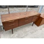 A RETRO TEAK AUSTINSUITE SIDEBOARD ENCLOSING SIX DRAWERS, 59.5" WIDE