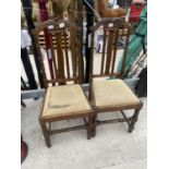 A PAIR OF EARLY 20TH CENTURY OAK HIGH BACK HALL CHAIRS