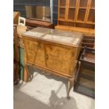 A MID 20TH CENTURY WALNUT COCKTAIL CABINET ON CABRIOLE LEGS, 35" WIDE