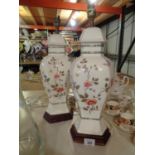 A PAIR OF DECORATIVE CERAMIC TABLE LAMPS WITH A FLORAL DESIGN (A/F - HAIRLINE CRACK)