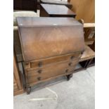 A MID 20TH CENTURY OAK BUREAU ON TURNED FRONT LEGS, 30" WIDE