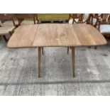 AN ERCOL STYLE DROP-LEAF DINING TABLE