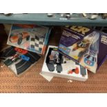 A BOXED TCR TOTAL CONTROL RACING TRACK AND CARS AND A BOXED KADER ROAD RACING TRACK AND CARS
