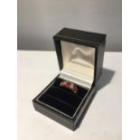 A 9 CARAT GOLD RING WITH THREE IN LINE RUBYS AND FOUR DIAMONDS SIZE P WITH A PRESENTATION BOX