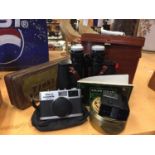 AN OLYMPUS 35RC CAMERA, A PAIR OF BINOCCULARS AND A VINTAGE TIN