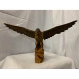 A WOODEN CARVED FIGURE OF AN EAGLE WITH ADJUSTABLE WINGS
