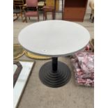 A ROUND WOODEN PUB TABLE WITH HEAVY CAST BASE