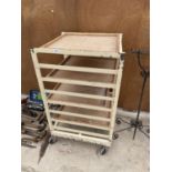 A FOUR WOODEN SHELVED POTTERS TROLLEY