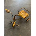 A VINTAGE TRICYCLE WITH A BUSBY BAND DECORATION