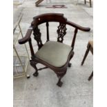 A GEORGE III STYLE CORNER CHAIR ON BALL AND CLAW FEET