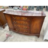 A MAHOGANY BOW FRONT SIDEBOARD WITH TWO DOORS AND FOUR DRAWERS