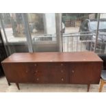 A RETRO TEAK SIDEBOARD WITH THREE DRAWERS AND TWO CUPBOARDS, 75" WIDE