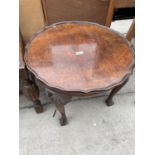 A MID 20TH CENTURY WALNUT LOW TABLE ON CABRIOLE LEGS WITH BALL AND CLAW FEET AND PIECRUST EDGE,