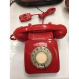 A RETRO RED DIAL UP TELEPHONE IN RED