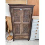 A GEORGE III STYLE OAK WARDROBE WITH TWO CARVED PANEL DOORS AND DRAWER TO THE BASE, 32.5" WIDE