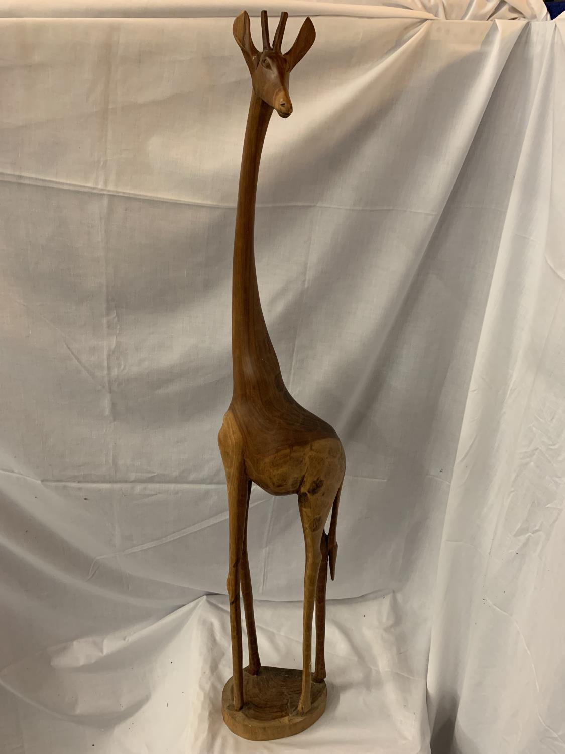 A TALL WOODEN GIRAFFE (REPAIR TO FOOT)