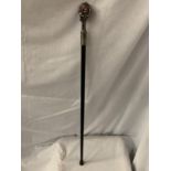 A BLACK WALKING STICK WITH A WHITE METAL SKULL TOP