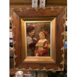 A DECORATIVE FRAMED PICTURE OF A COURTING COUPLE