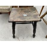 A VICTORIAN ELM STOOL ON FOUR TURNED LEGS